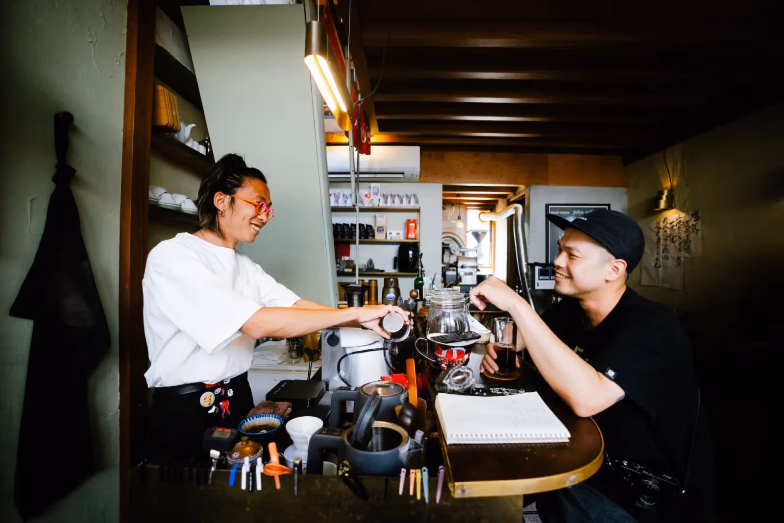 Rail Coffee's owner with coffee cups and equipment