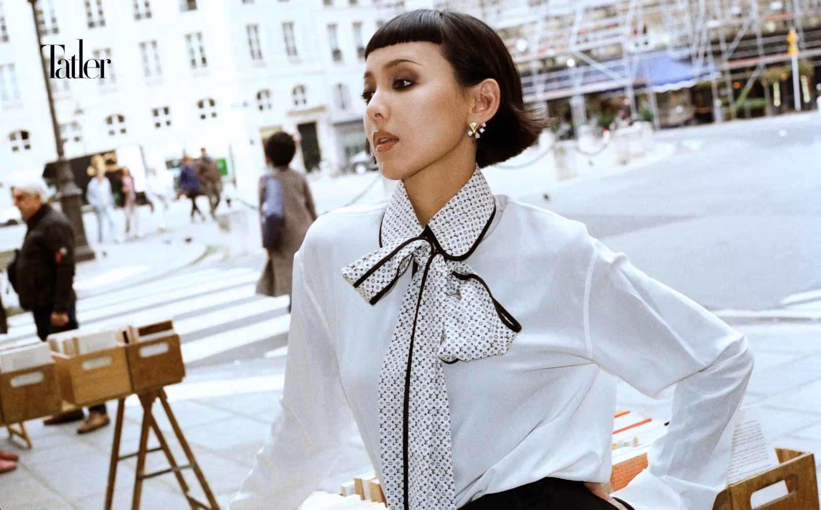 Bow-tie blouse, black trousers, earrings, all by Louis Vuitton