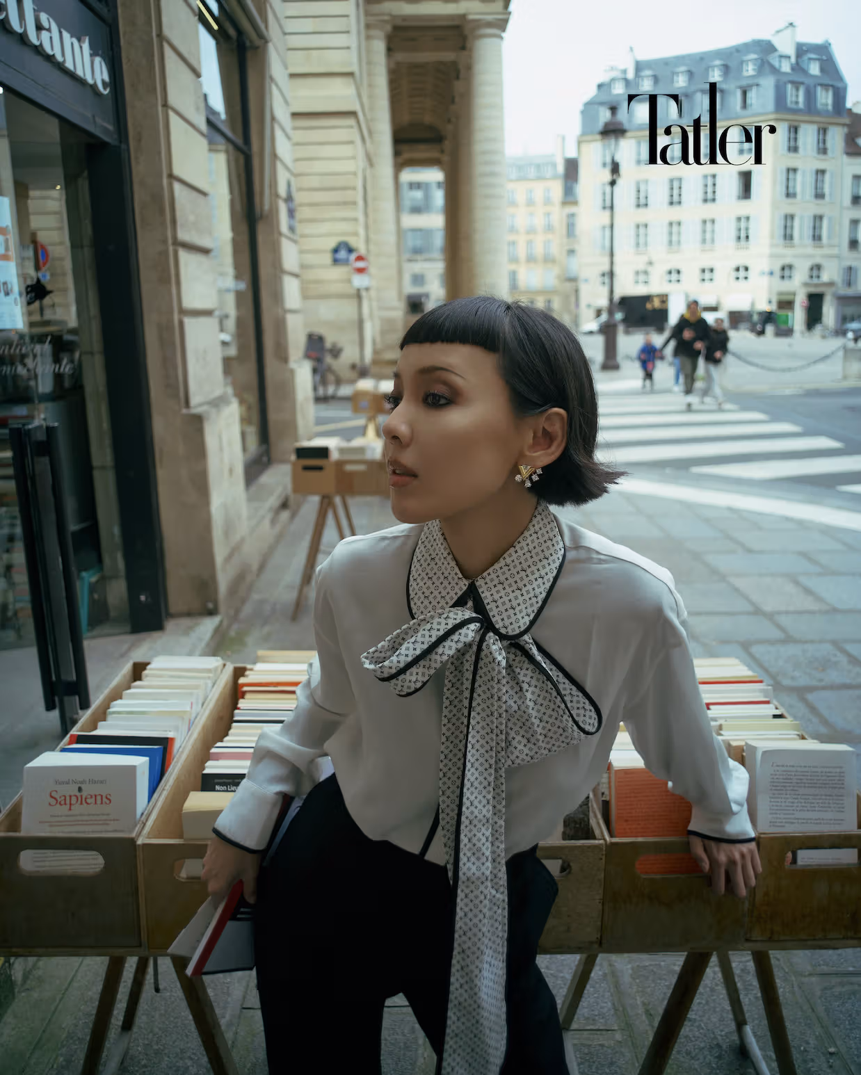 Bow-tie blouse, black trousers, earrings, all by Louis Vuitton