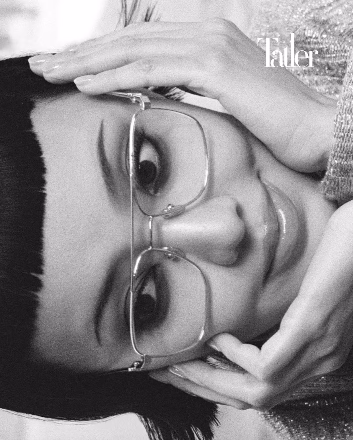 Loose shimmering knit cardigan, flared-sleeve bow-collar blouse, eyeglasses, all by Louis Vuitton