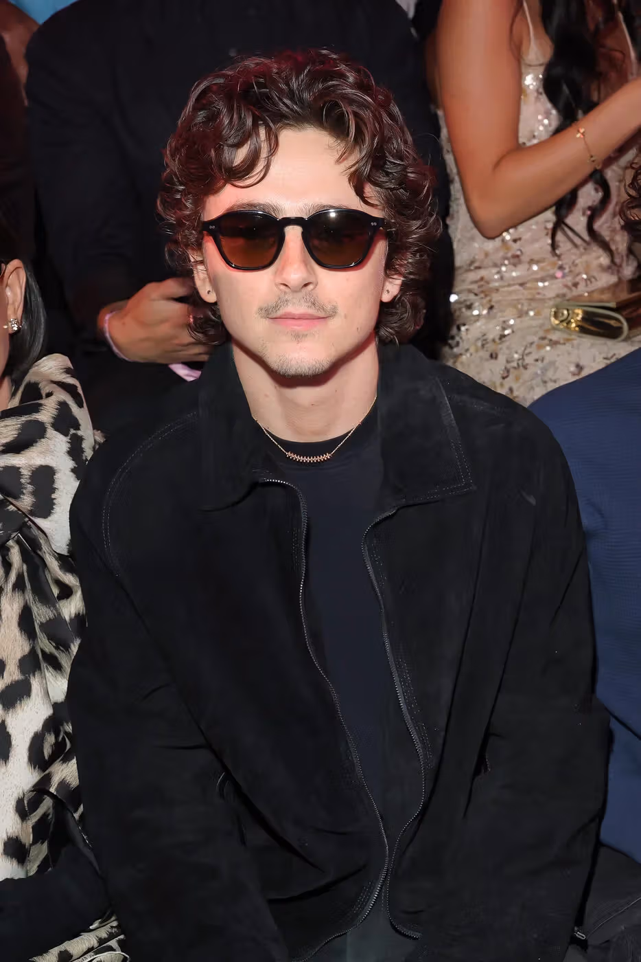 Dark jacket and sunglasses for public occasions