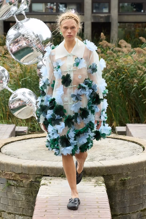 Susan Fang light-colored clothing and floral arrangements
