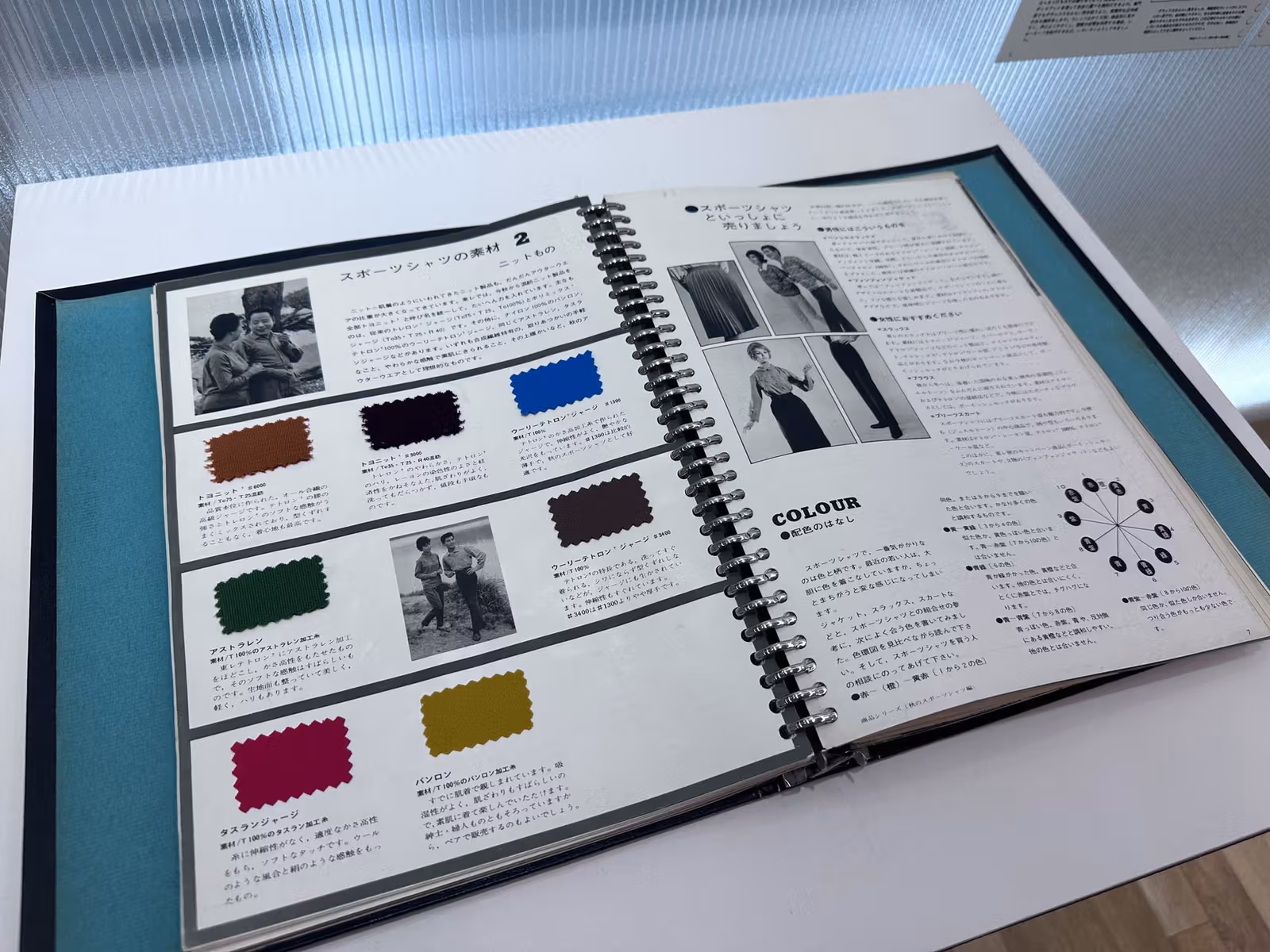 Historical material and textile samples on a table at Toray’s centenary exhibition