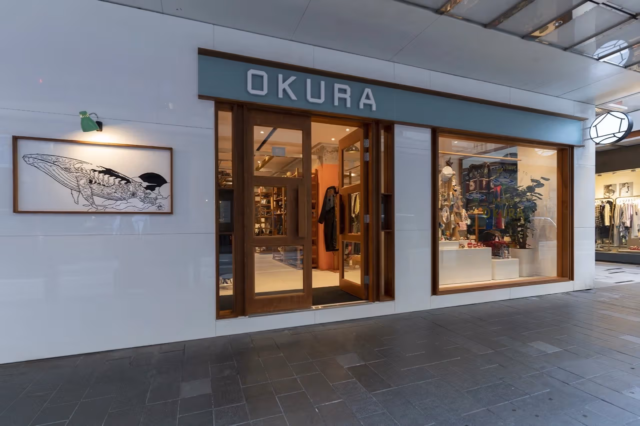 OKURA grey-blue shopfront, wooden door frame and display window