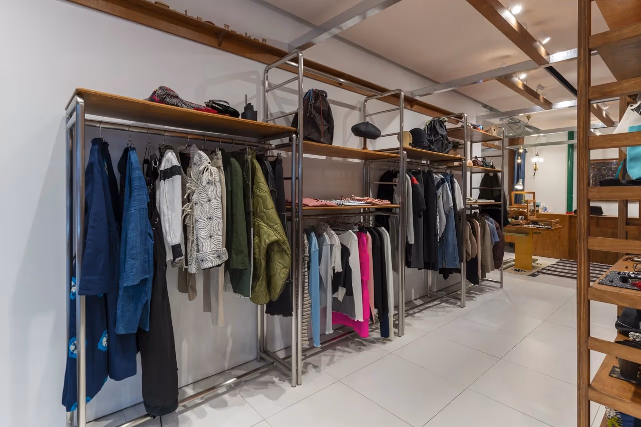 Jackets, tops and everyday objects displayed inside OKURA