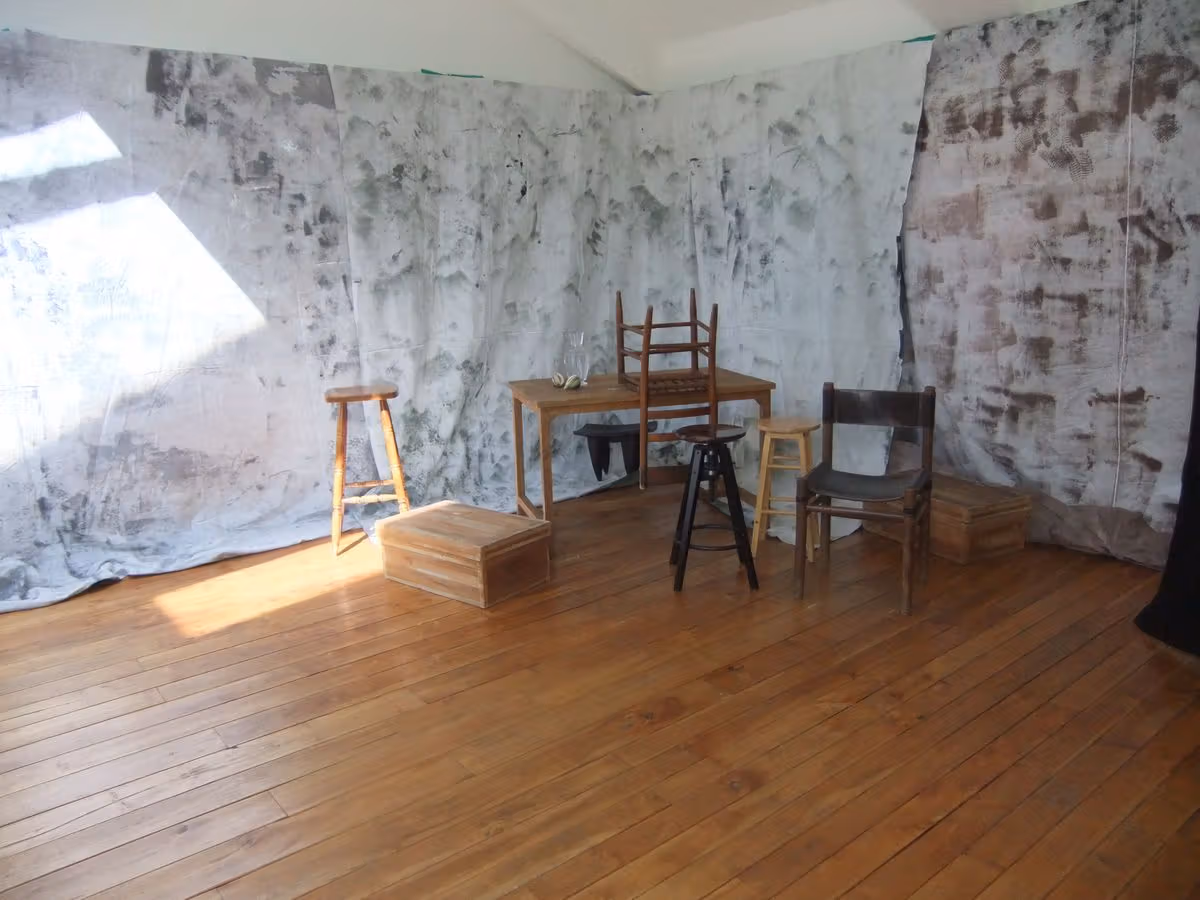 Wall texture, furniture and natural light remain visible in the shooting space.