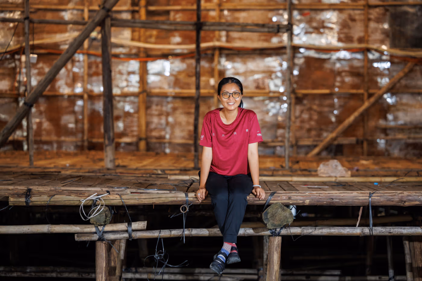 Sze Ka-yan wearing red and seated beside the bamboo stage