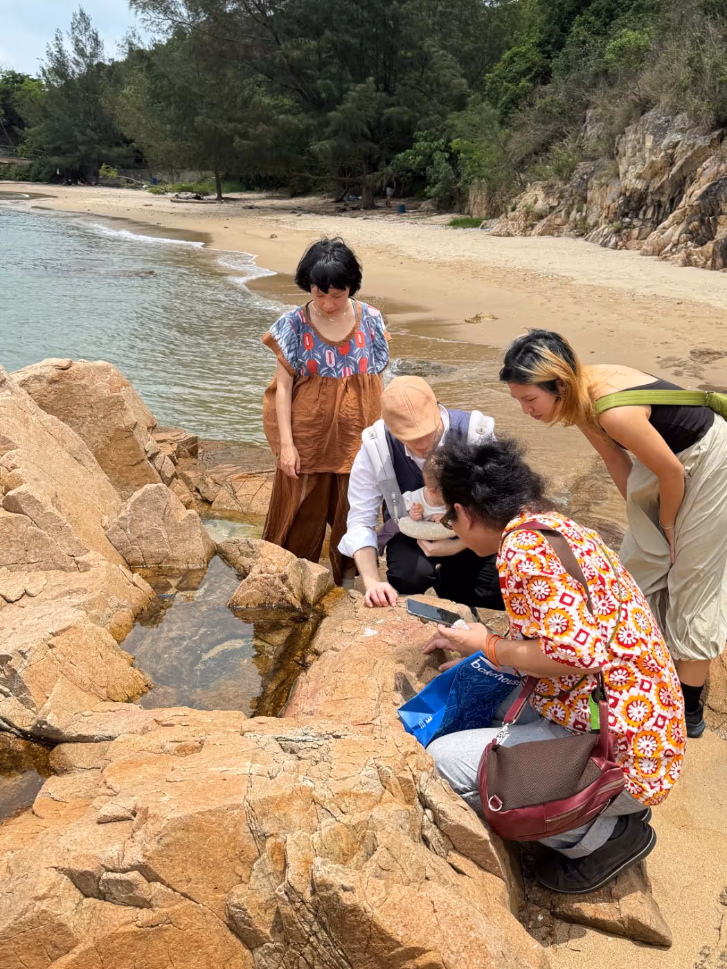 Participants making a field visit beside rocks on Peng Chau’s coast
