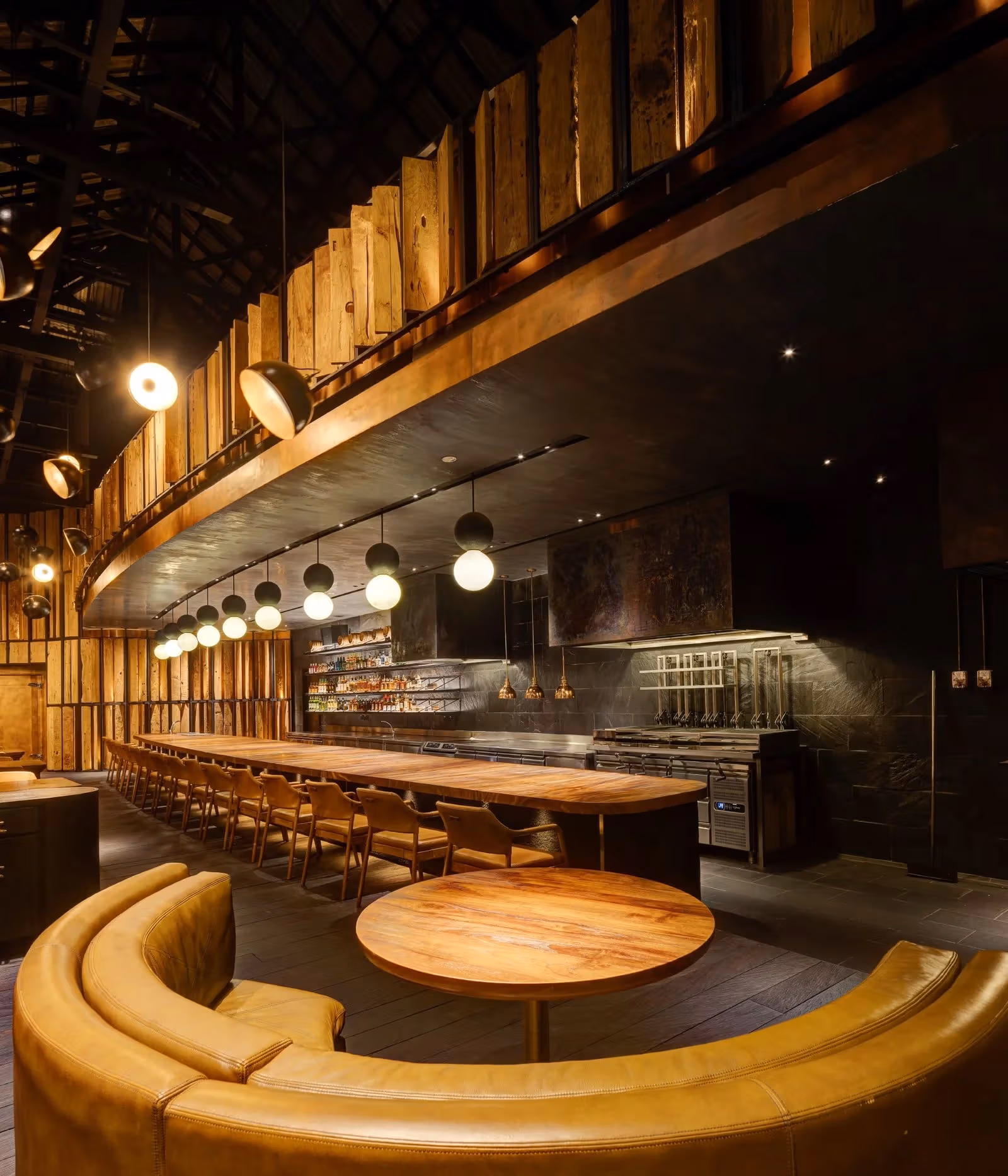 Long counter, round table and open kitchen at Burnt Ends in Singapore