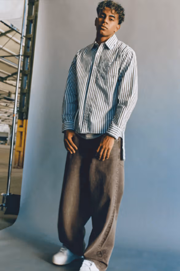 Lamine Yamal ใส่เชิ้ตเส้นฟ้าขาวกับกางเกงกว้างเข้ม