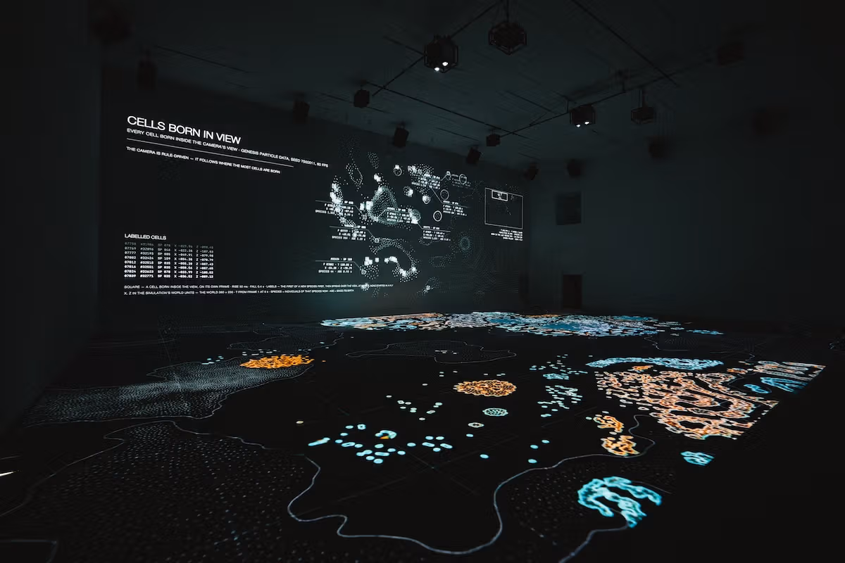 Wall and floor projections form a changing artificial-life environment.