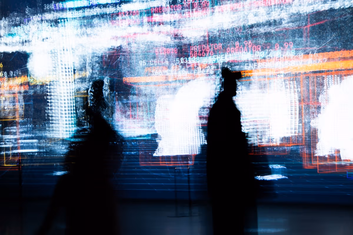 Moving silhouettes overlap with the exhibition’s audiovisual imagery.