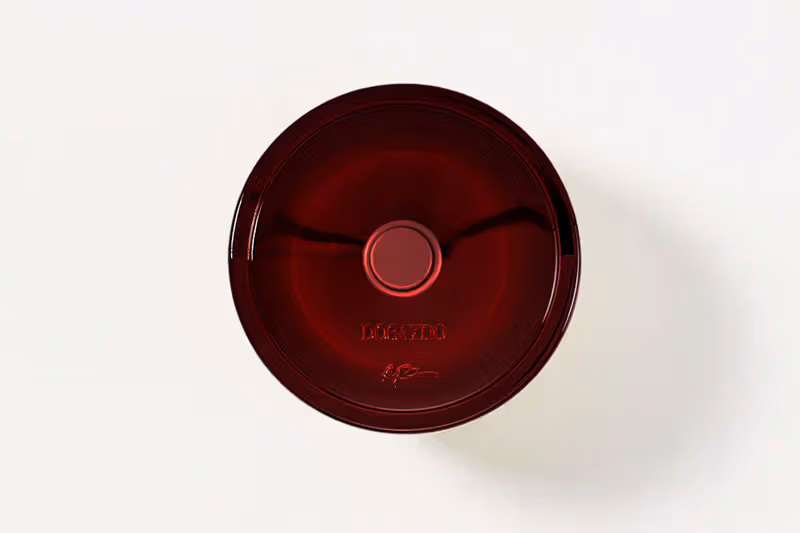 Overhead view of the deep-red DoSayDo glass perfume bottle
