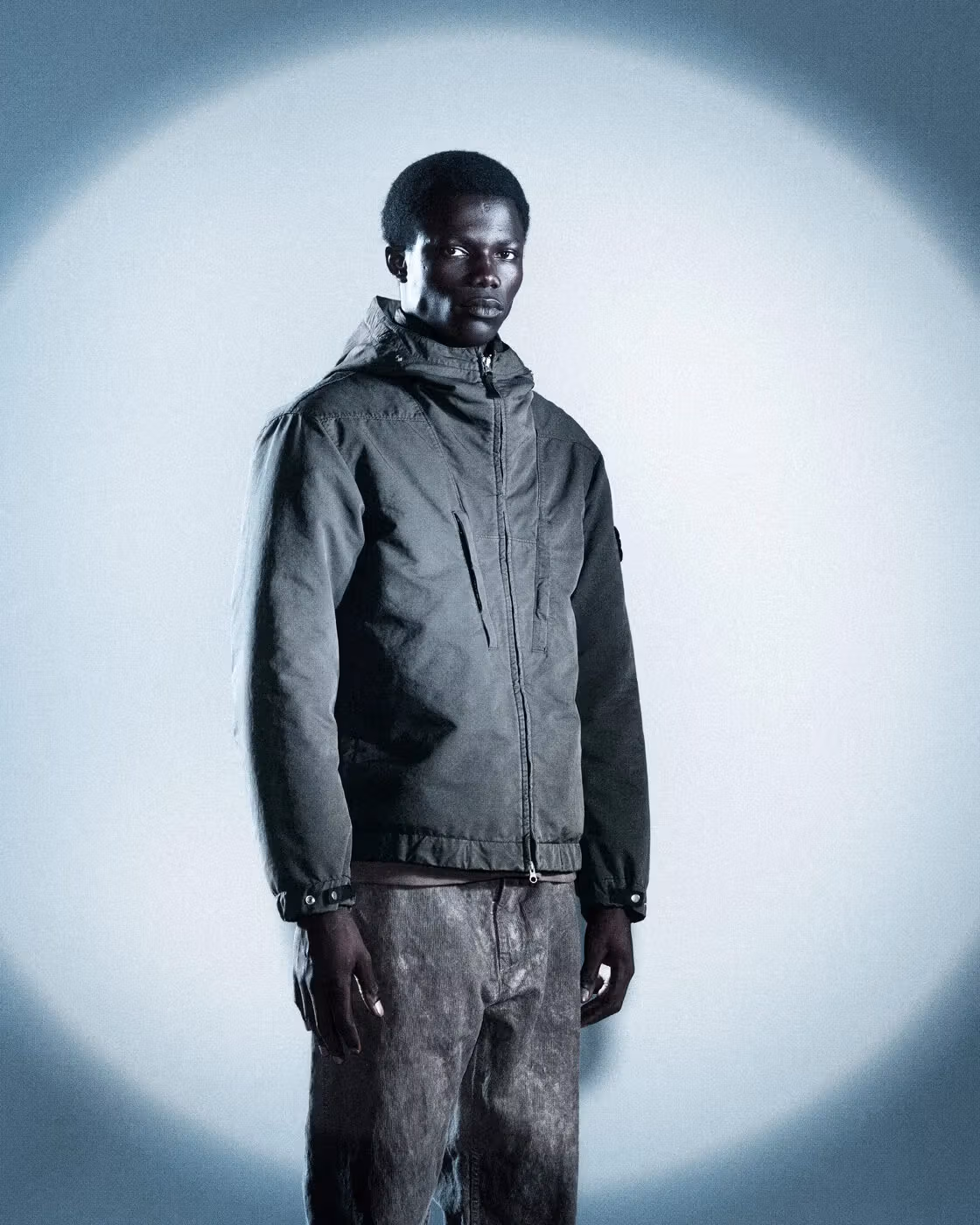 A full-length look featuring a hooded jacket with a quieter surface.