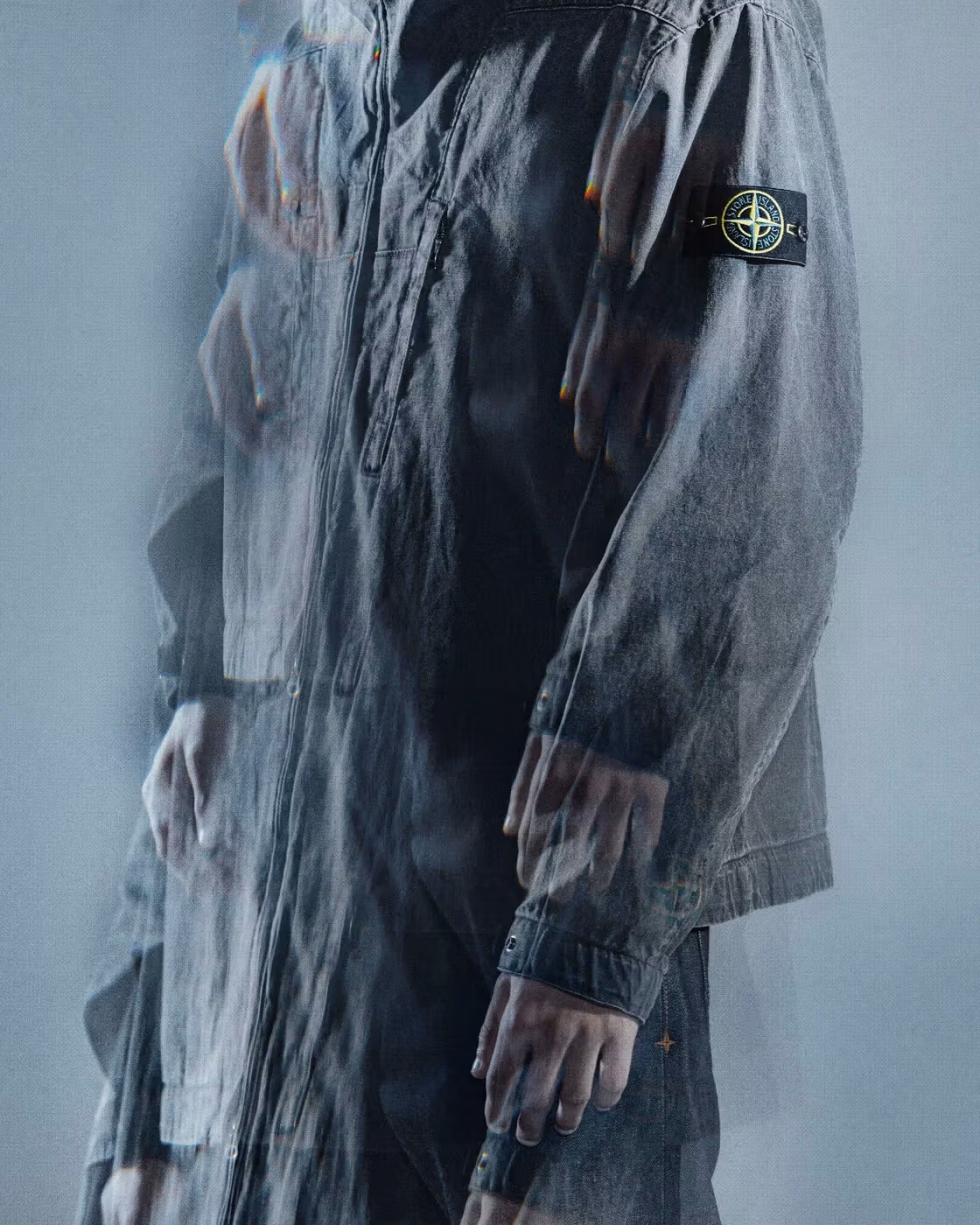 Sleeve fabric texture and the Stone Island badge in detail.