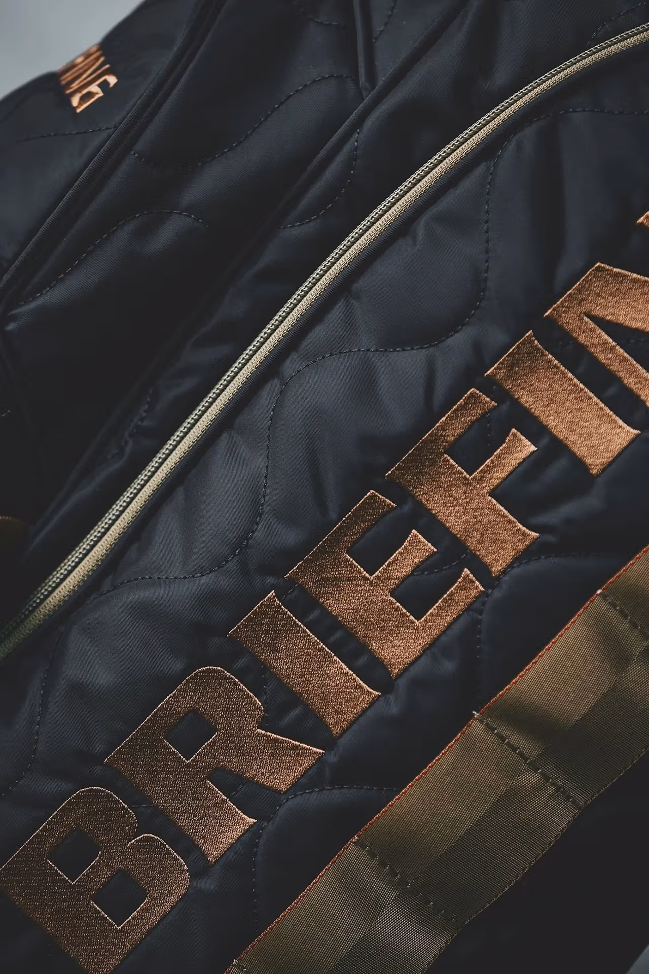 MIL collection branding and quilted fabric detail