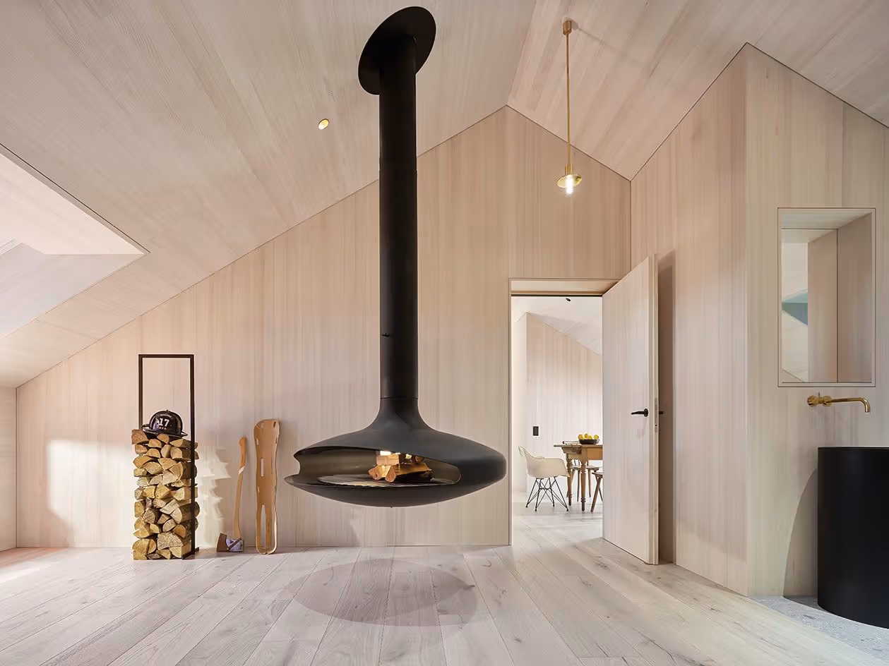 House in Process timber interior and suspended fireplace