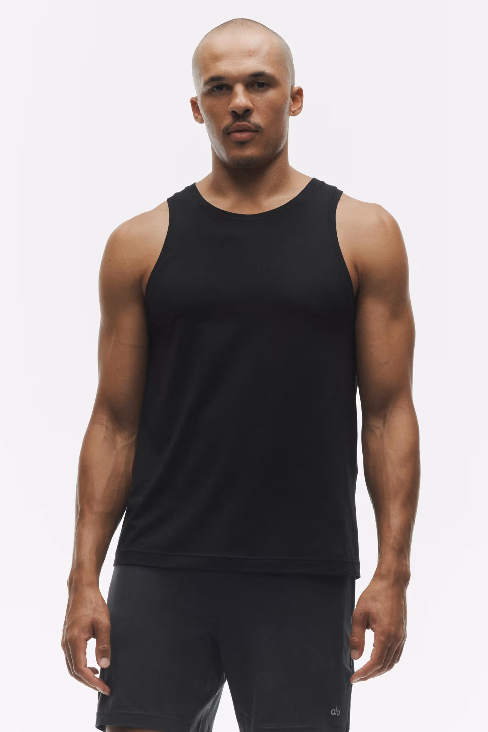 Official close-up of the black Conquer Muscle Tank, showing its crew neck and wide armholes. Taken in a separate shoot from SILENT MOVE.
