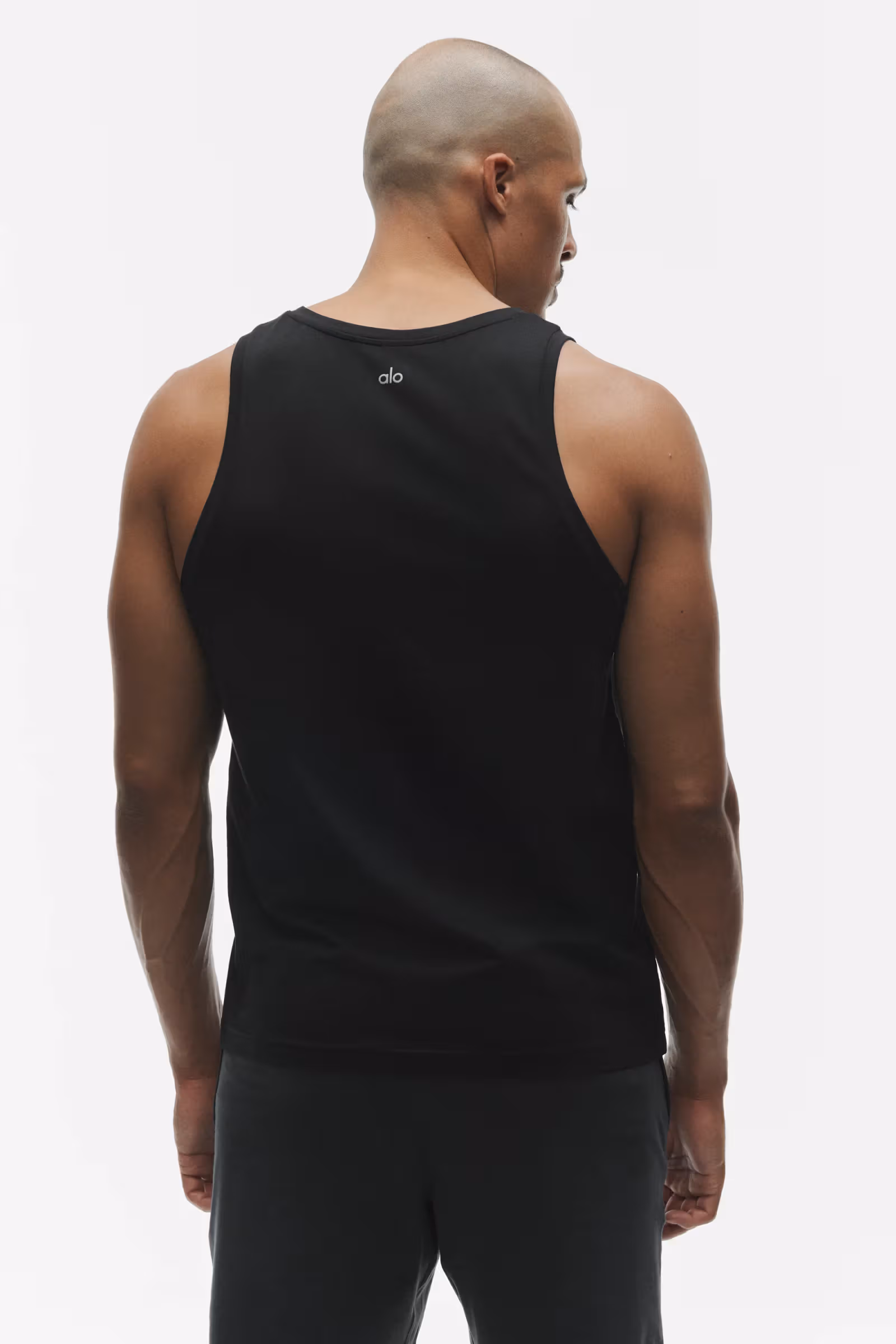 Official rear view of the black Conquer Muscle Tank; the logo is part of the garment’s original design. Taken in a separate shoot from SILENT MOVE.
