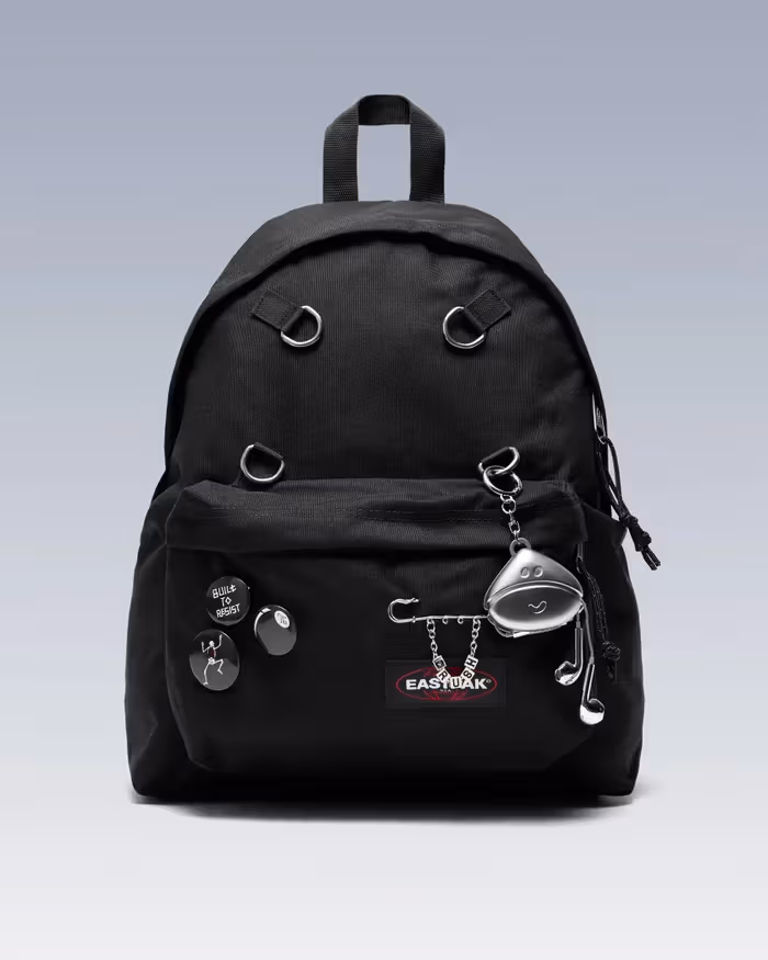 Front view of the black collaboration Padded Pak’r with four metal D-rings, badges and charms.
