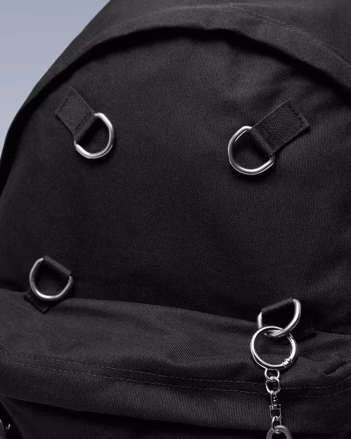Black webbing secures the D-rings to the bag, providing attachment points for accessories.