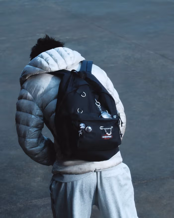 A rear-view campaign image of Crush wearing the collaboration, with decorations concentrated on the bag’s outside.