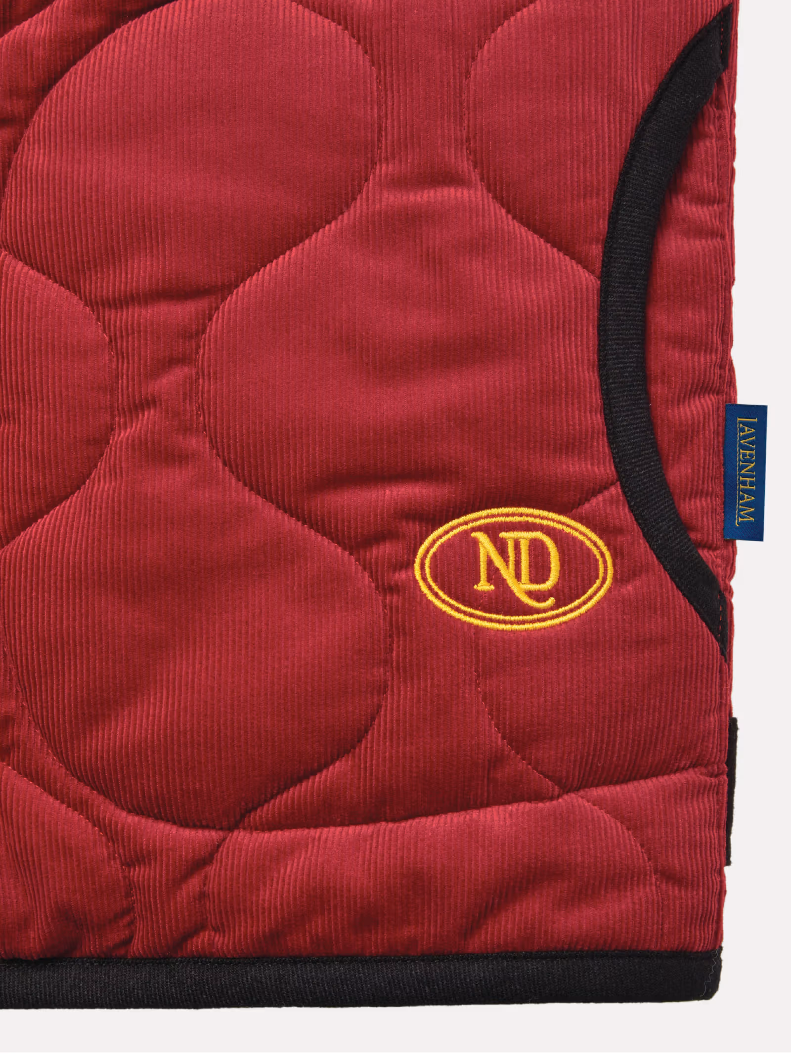 Yellow ND embroidery beside the red jacket pocket