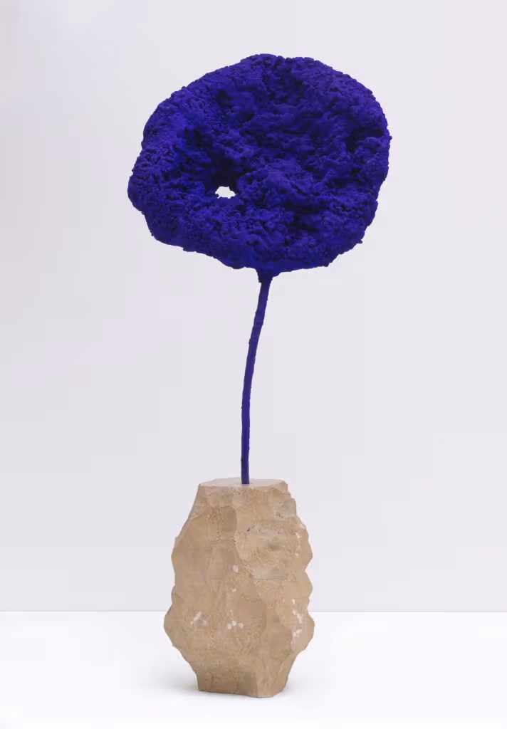 Porous blue sponge sculpture on a slim support and base