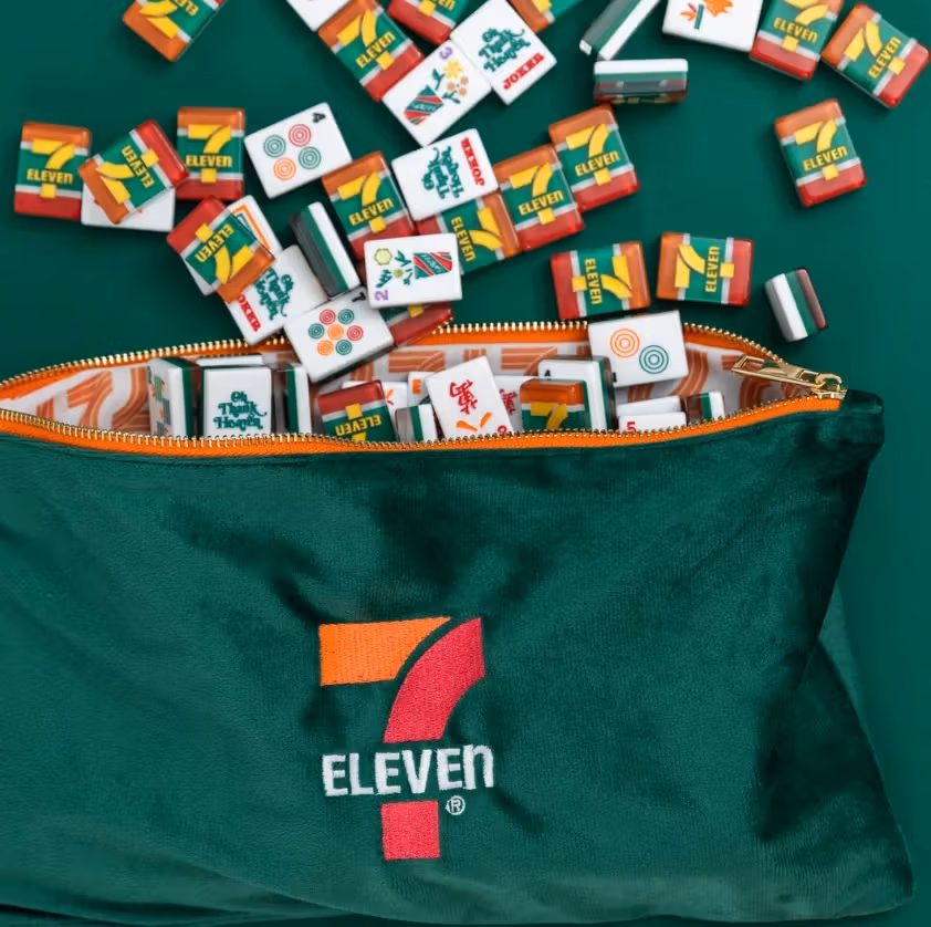 Green 7-Eleven bag with scattered mahjong tiles