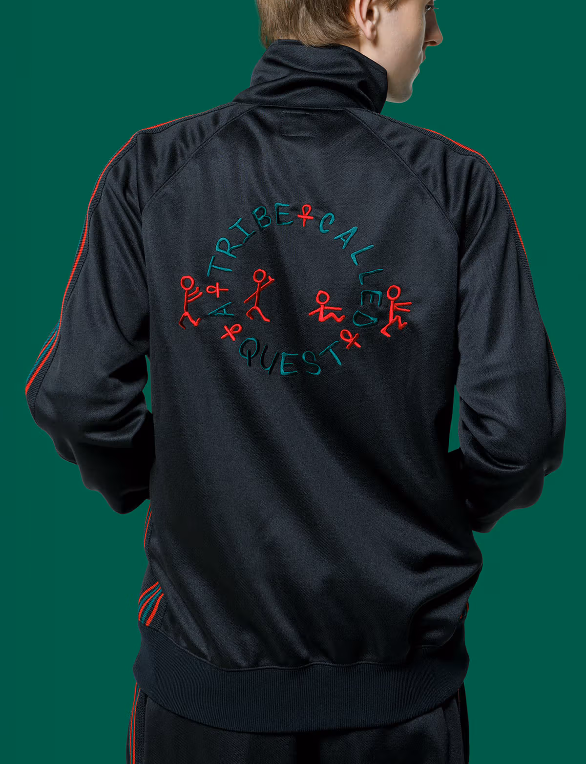 Red-and-green embroidery on the back of the NEEDLES ATCQ track jacket
