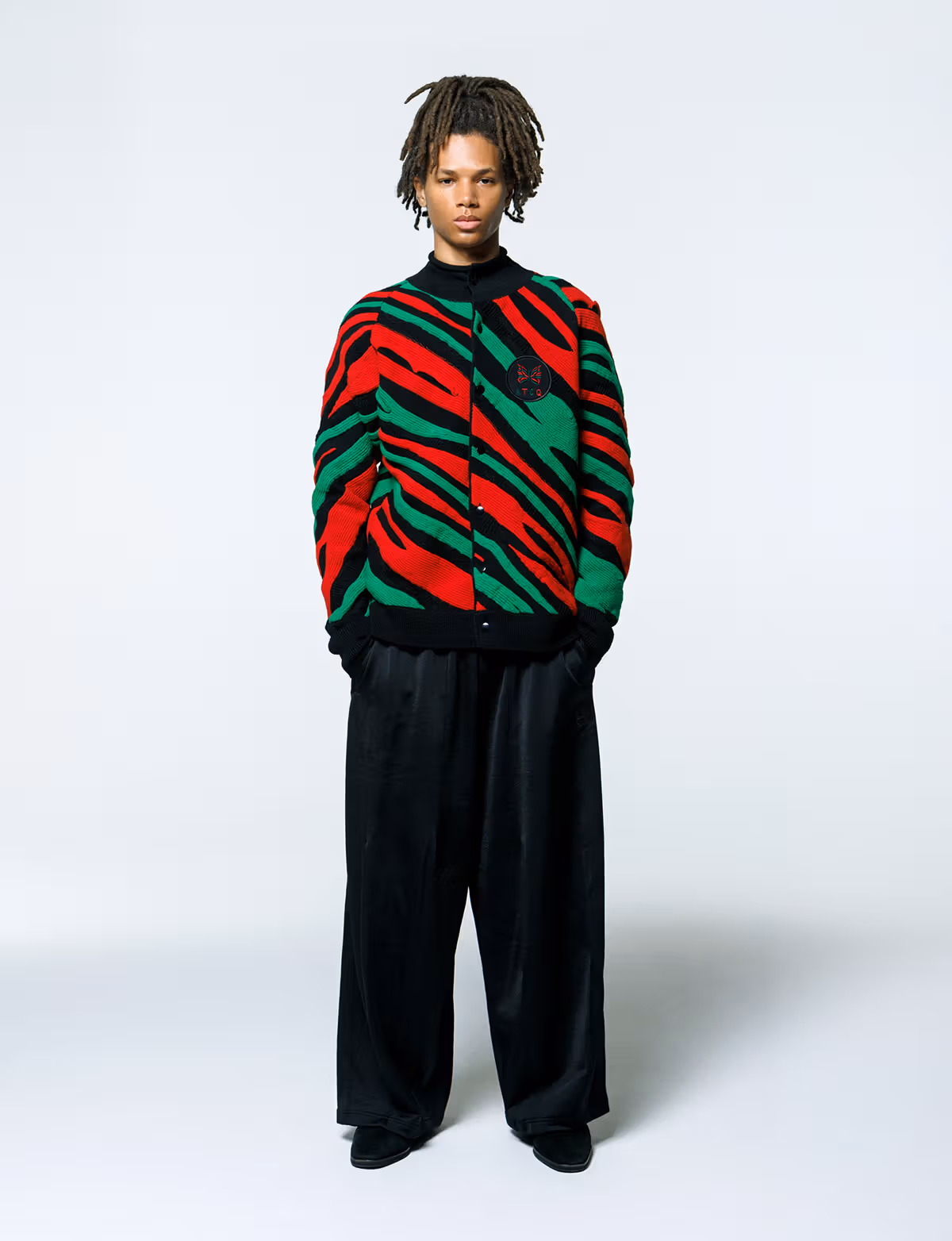 Model wearing the red, green and black Roll Neck Cardigan