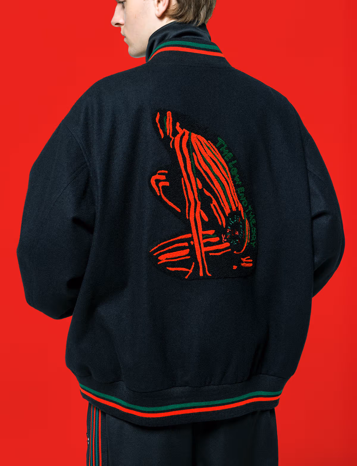 Red figure motif on the back of a black baseball jacket