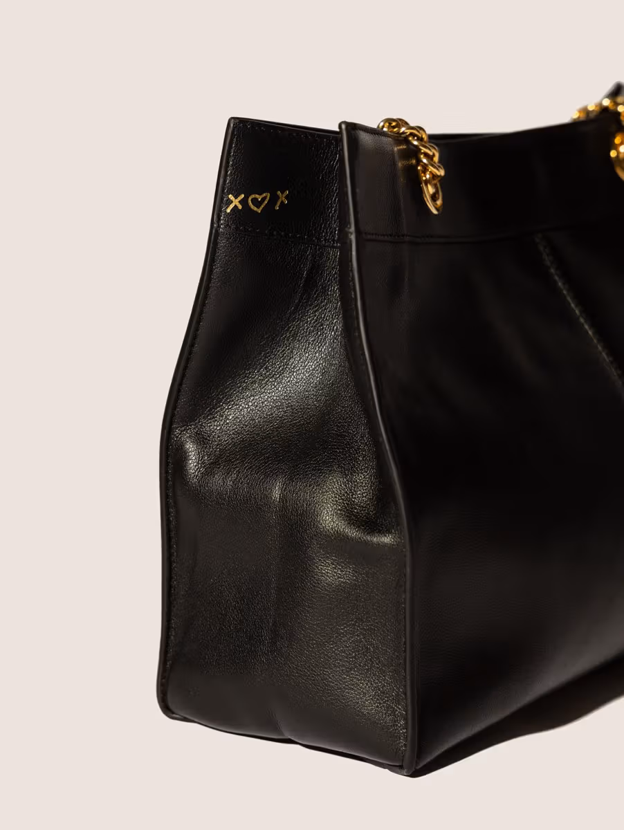 Gold-coloured symbols on the side of the black tote