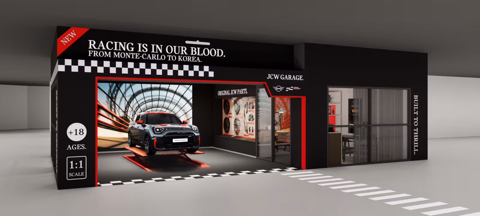 黒と赤の模型箱型ファサード、チェッカー模様、車両でJCW Garageの構想を示す公式イメージ。