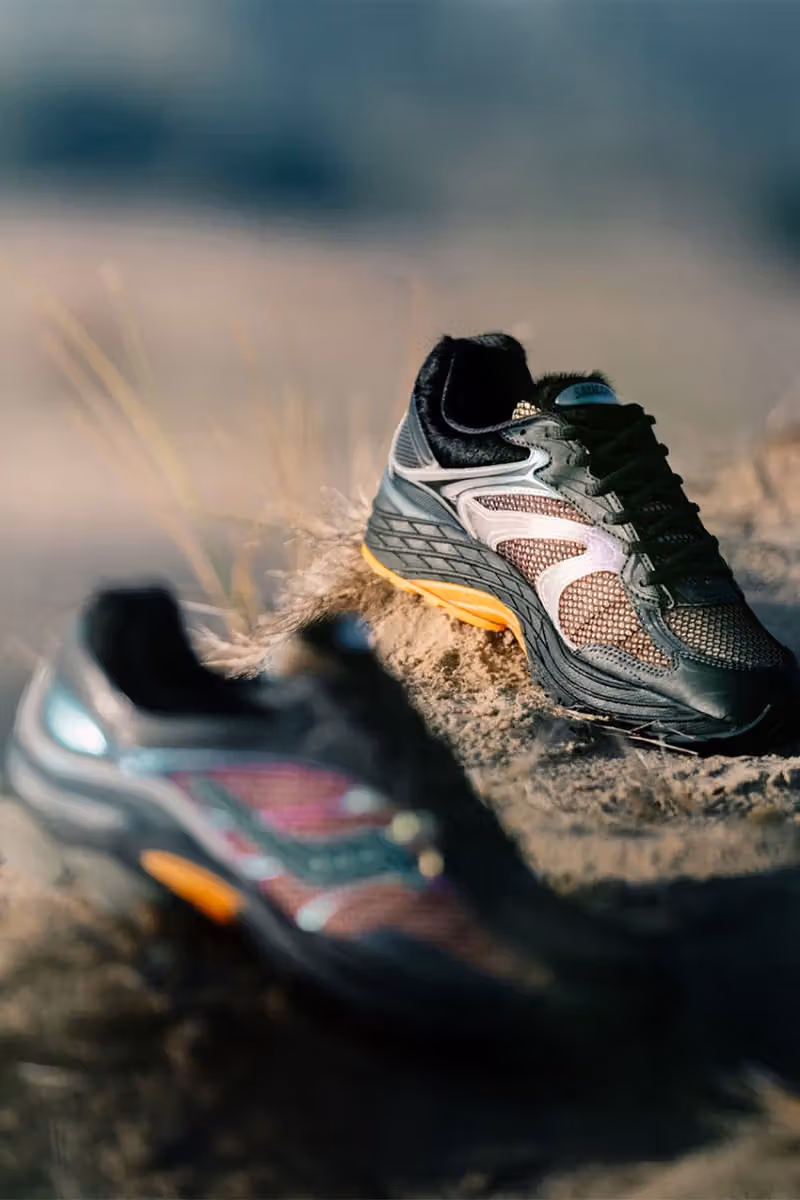 Iridescent dark runners on dry ground, with the rear shoe in sharper focus