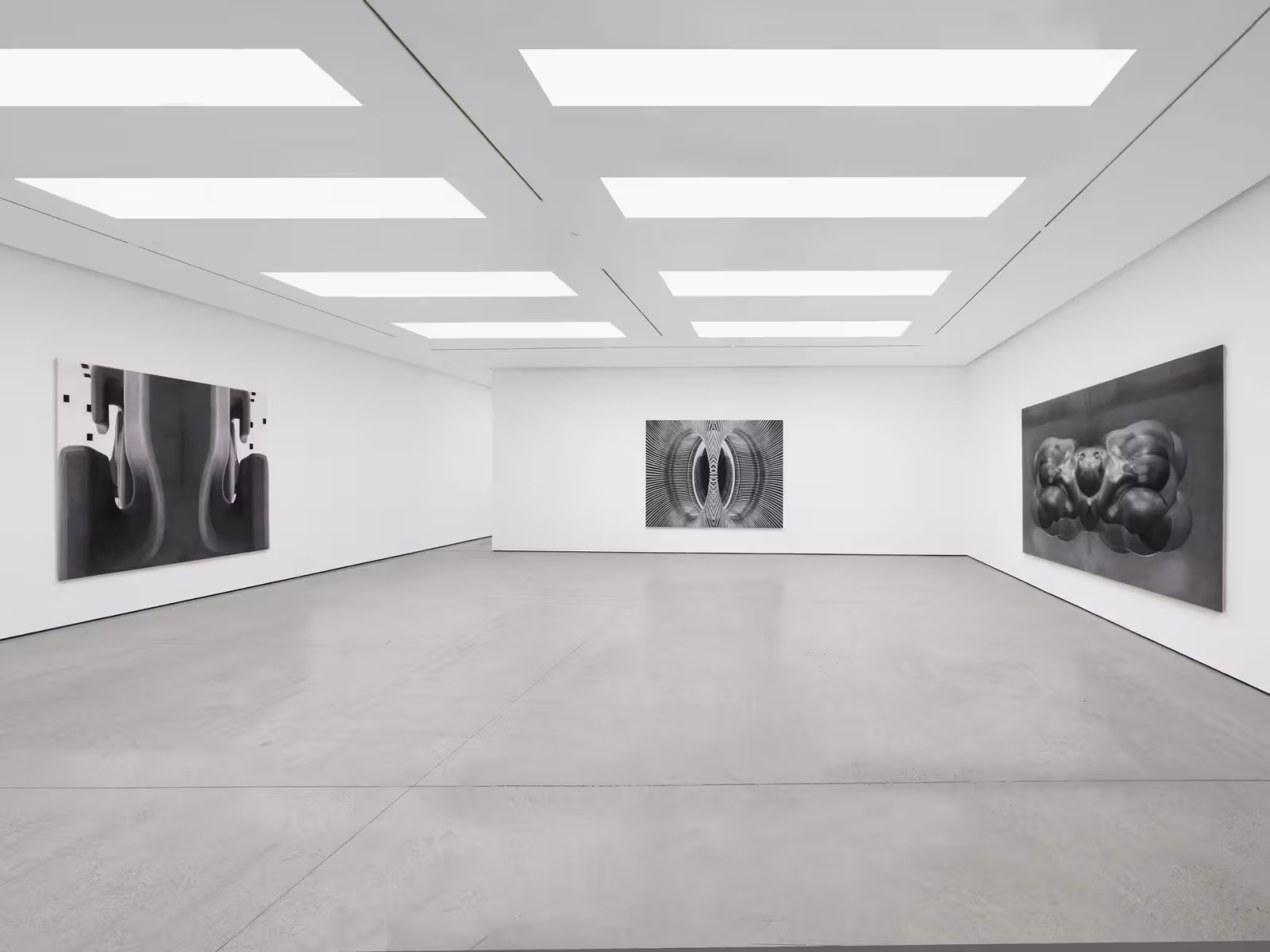 白色展间三面墙分别挂有大型灰阶绘画，右侧为圆润对称形体